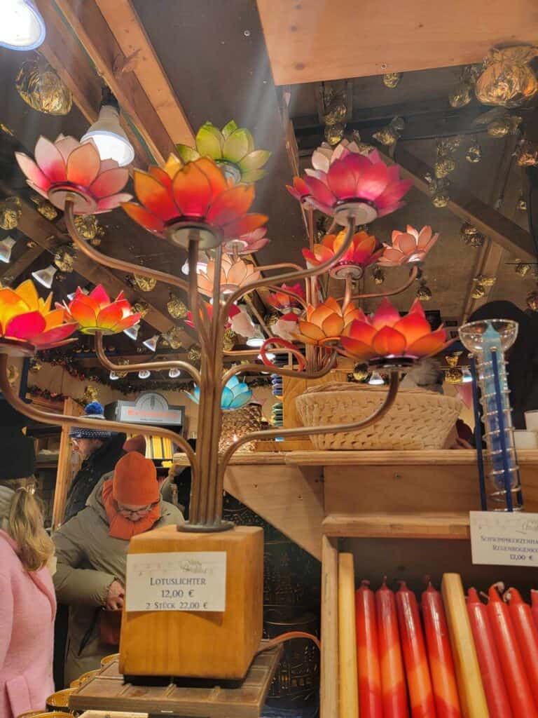 A booth selling candles and stained glass lotus lamps