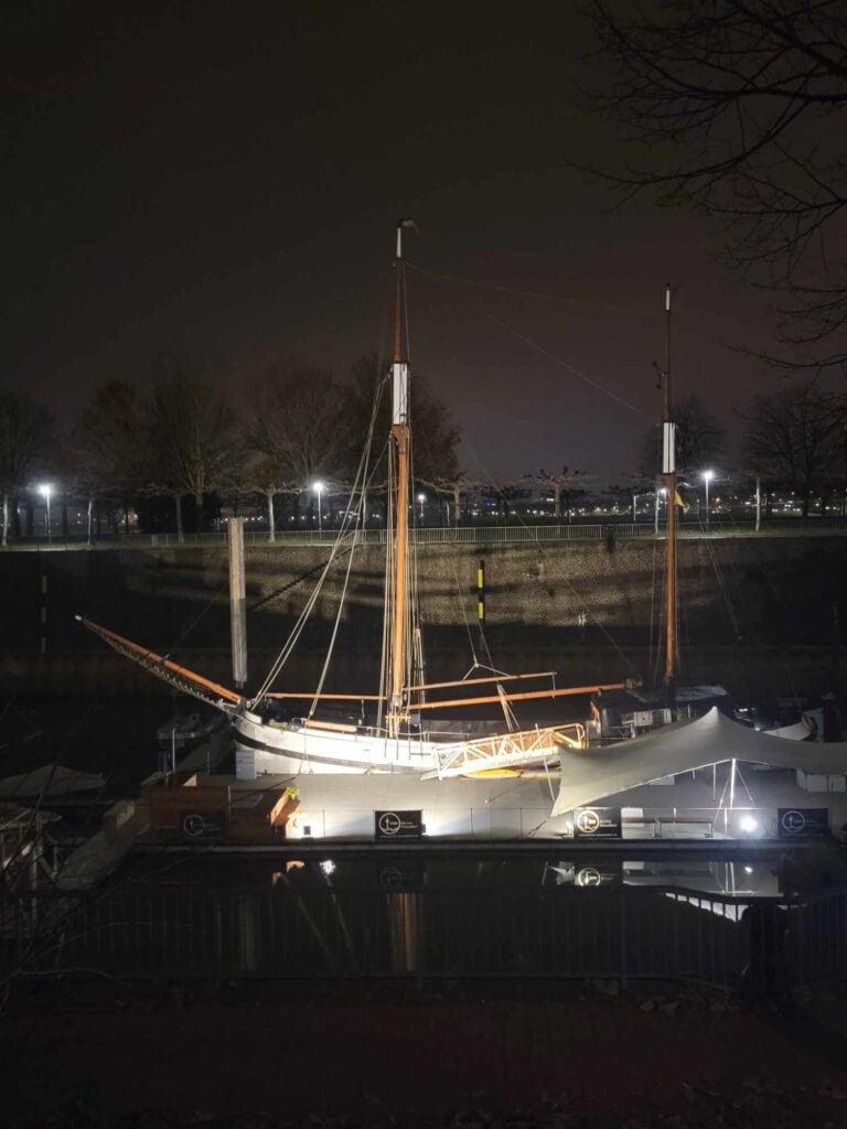 A sailboat in a slip at night