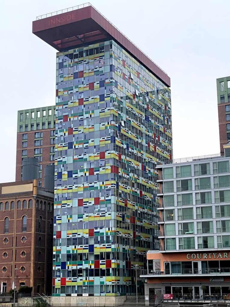 An ultramodern rectangular hotel covered with primary colored patches.