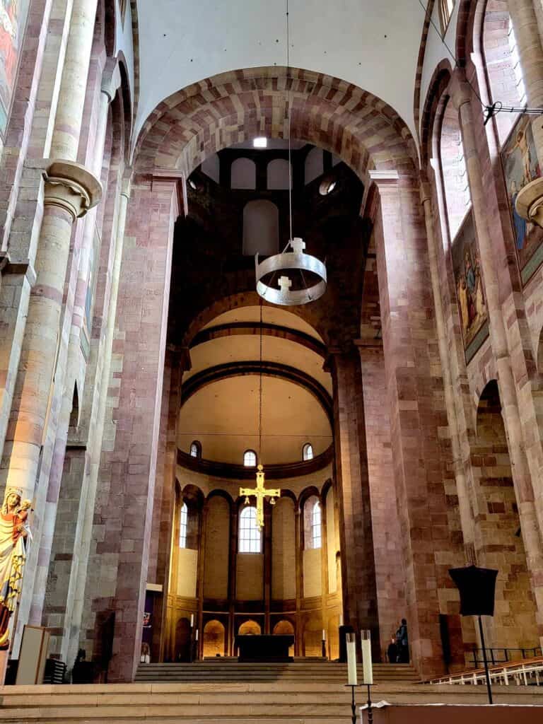 The altar of the Speyer cathedral with a silver crown suspended overhead