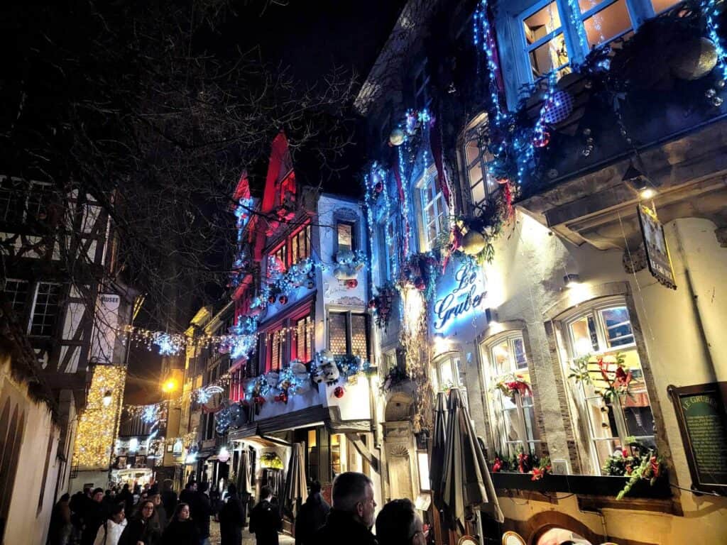 Half timbered buildings and quaint shops decorated in lavish garlands with stars, lights, and ornaments