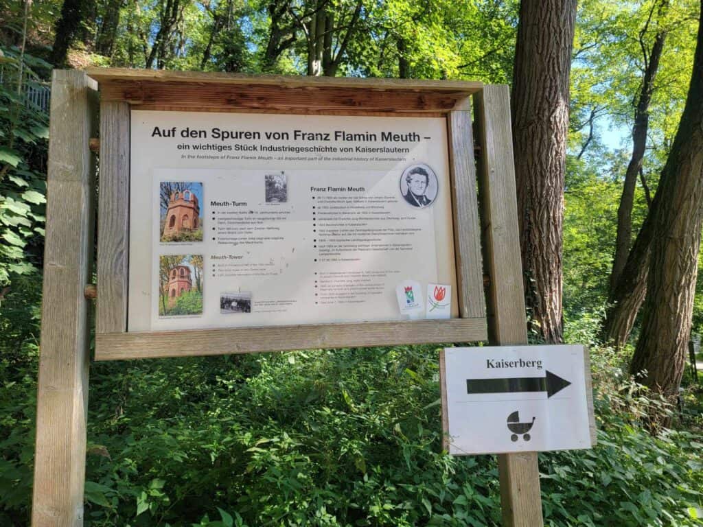 A sign describing the Meuth tower and a sign pointing to Kaiserberg with a baby carriage icon