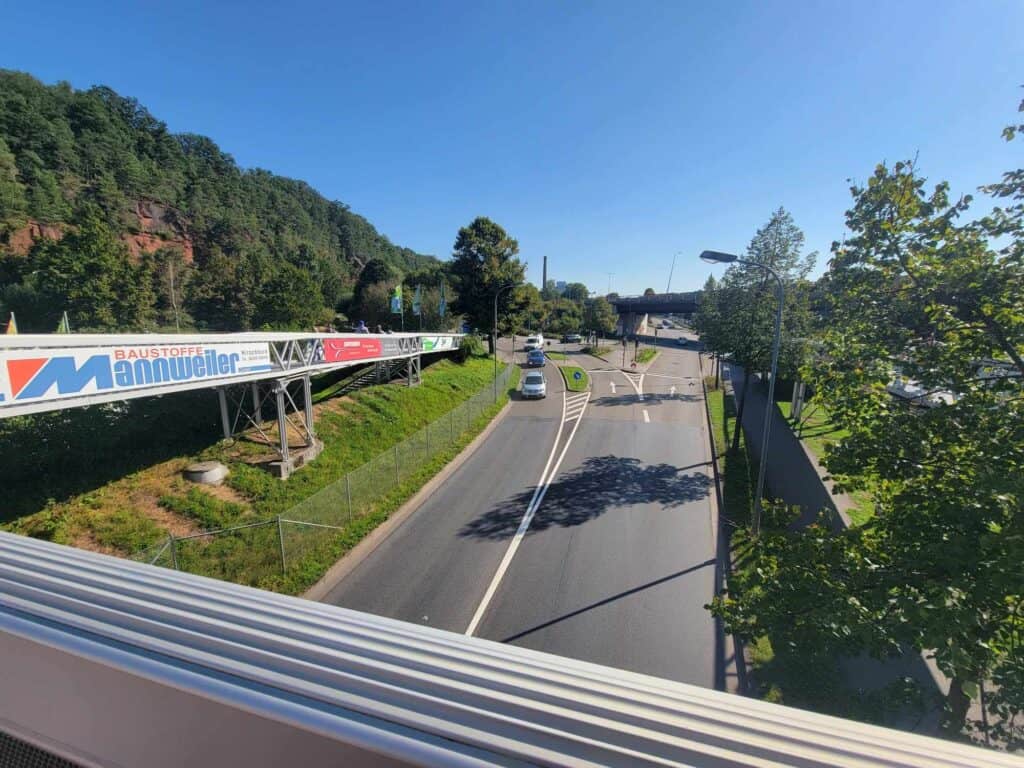 A narror pedestrian bridge crossing the highway