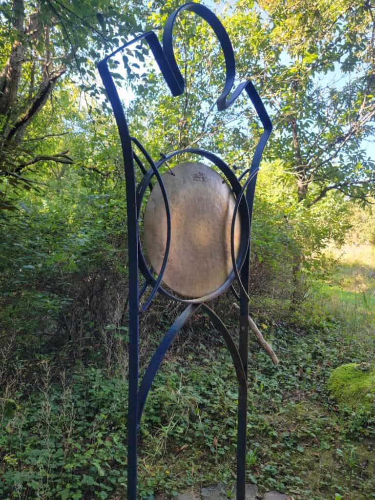 A gong on a frame that looks like a person