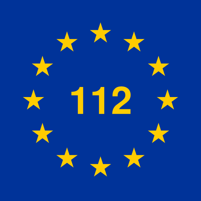 The blue flag with gold stars in a circle of the European Union and the number 112 in the center