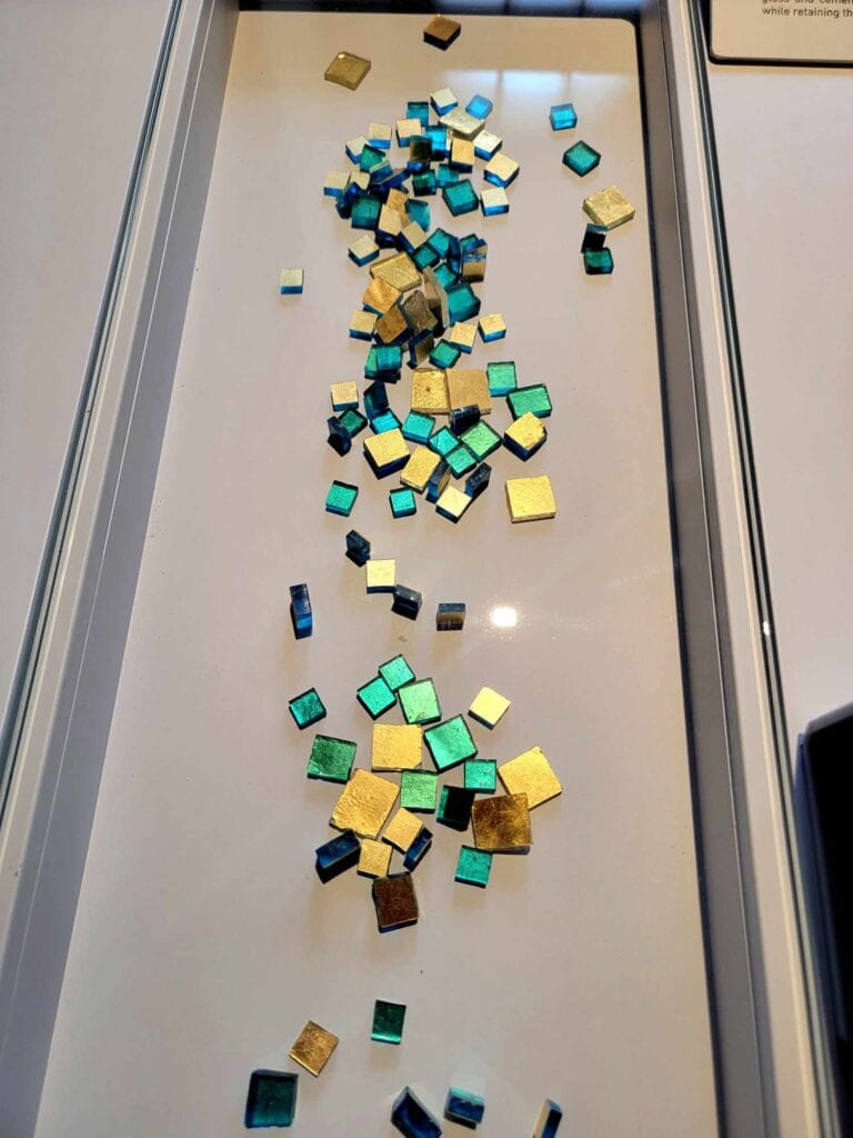 Small glass tiles in opalescent green, blue, and gold leaf