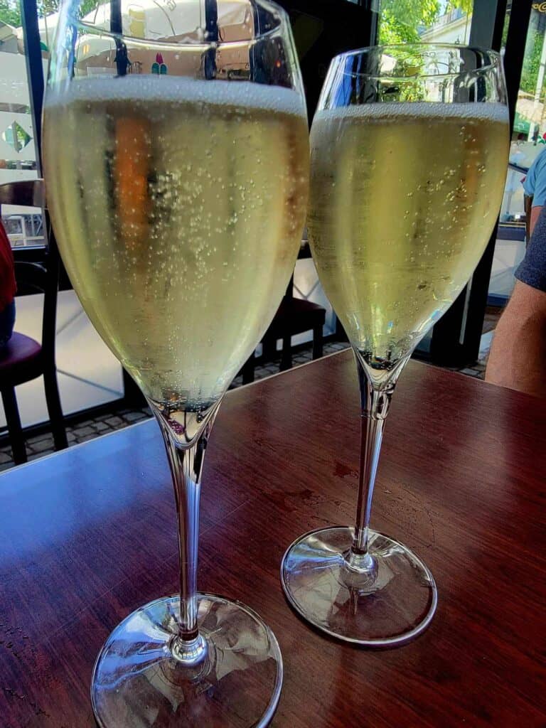 Two glasses of champagne on a wooden table