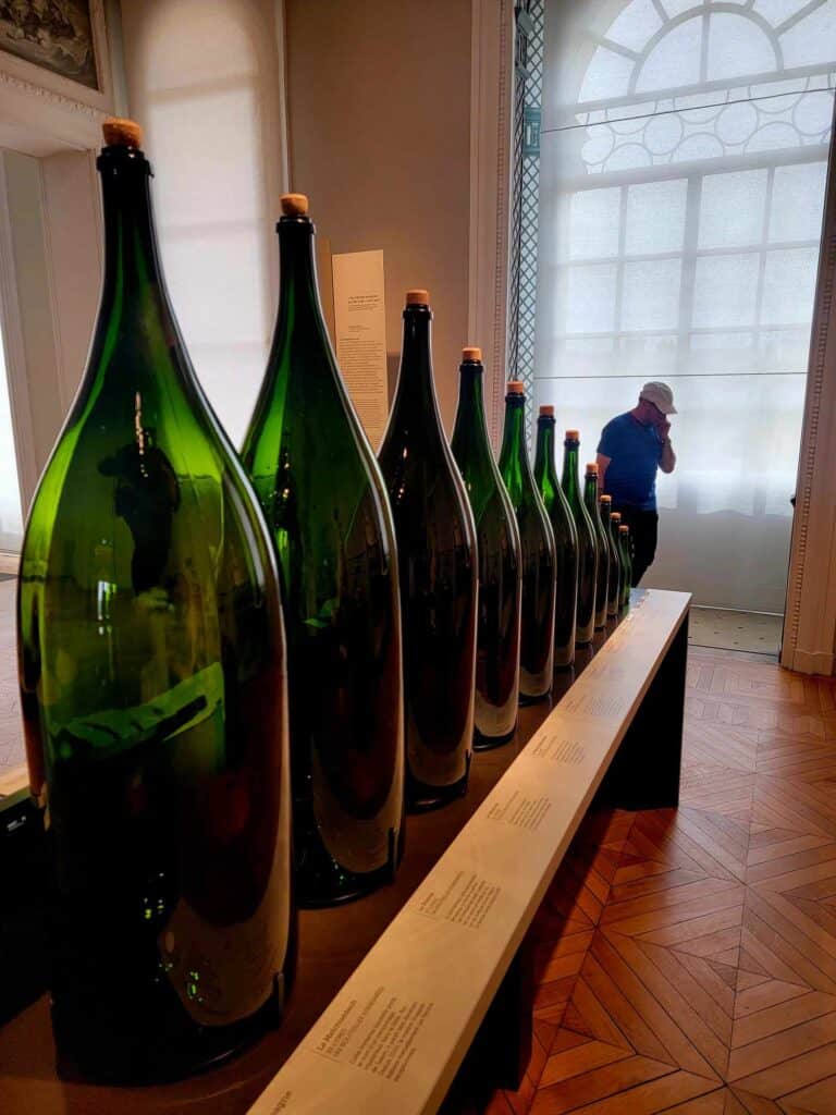 A line of graduated green glass champange bottles