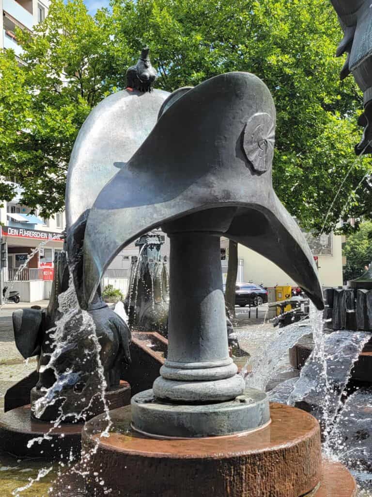 A large bronze Napoleon's hat with water flowing out the sides