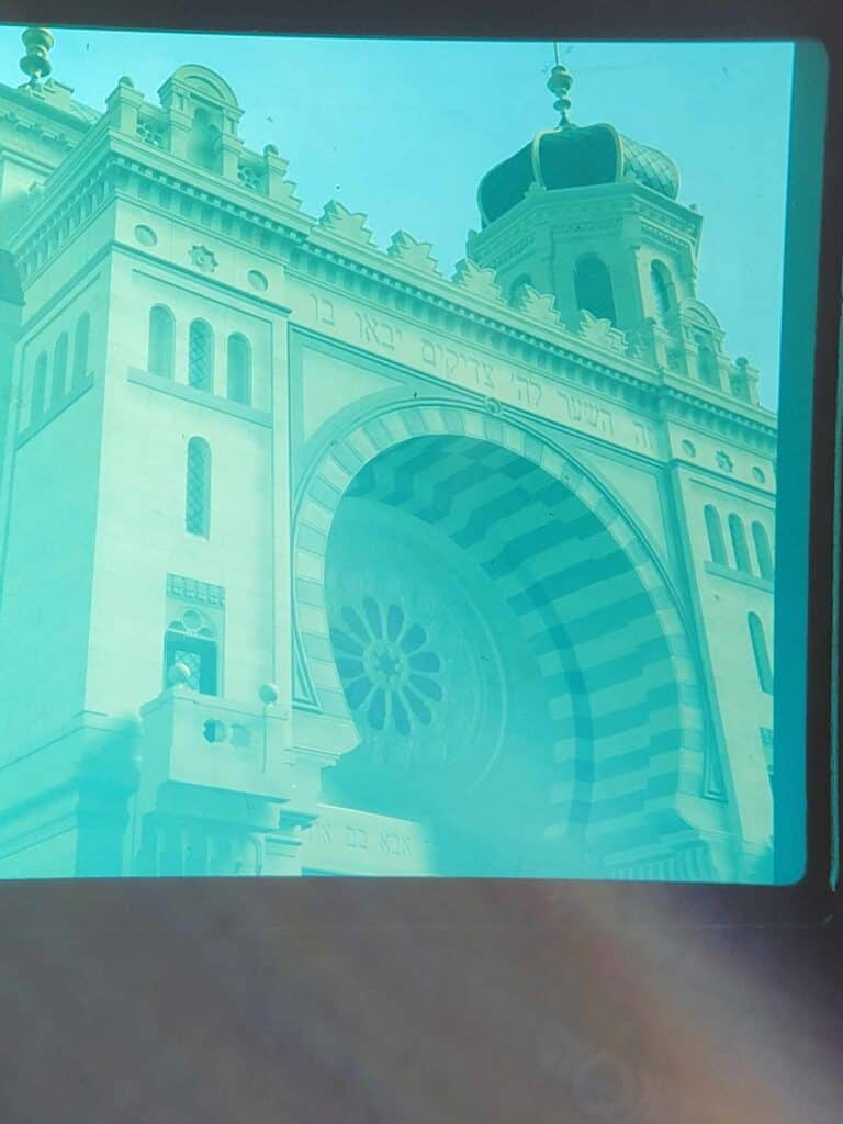 The greenish faded ghostly. image of the front of the synagogue