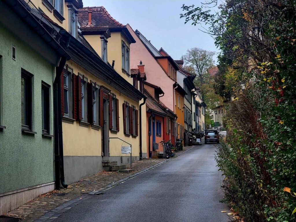 A row of colorful houses on a sloped street