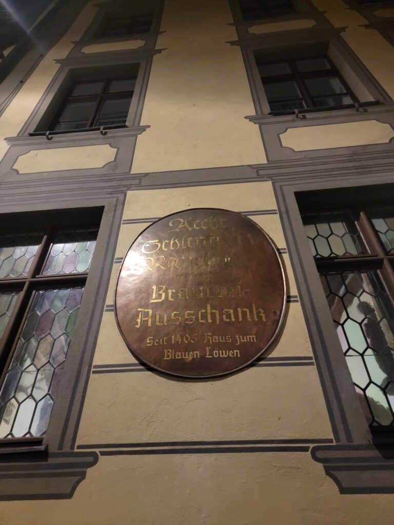 A round bronze sign for Scherlenka brewery 