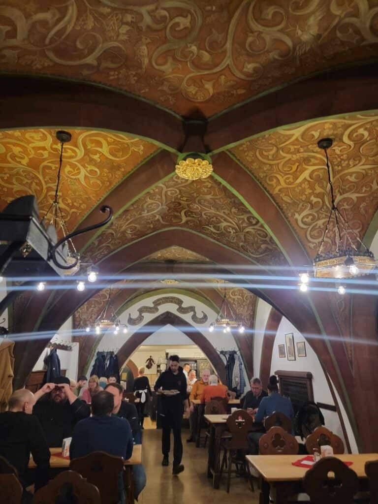 An arched room with gold fresco patterns on the ceiling