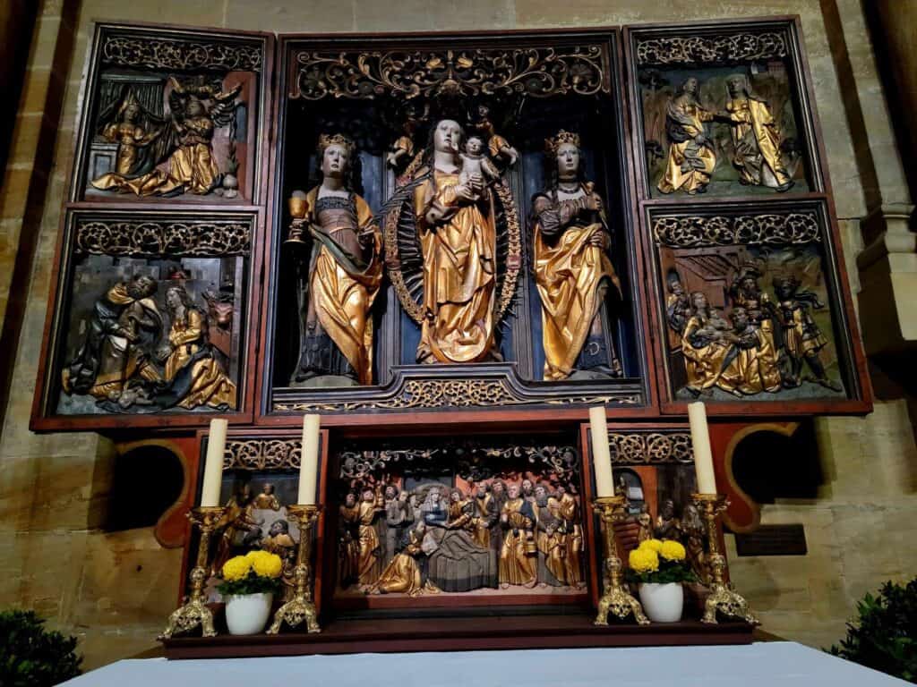 A Medieval carved wooden relief of Mary with baby Jesus, flanked by two female saints