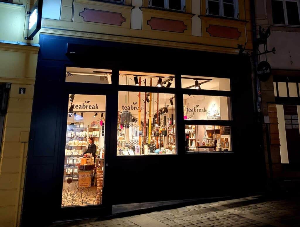 The store front of a tea shop at night