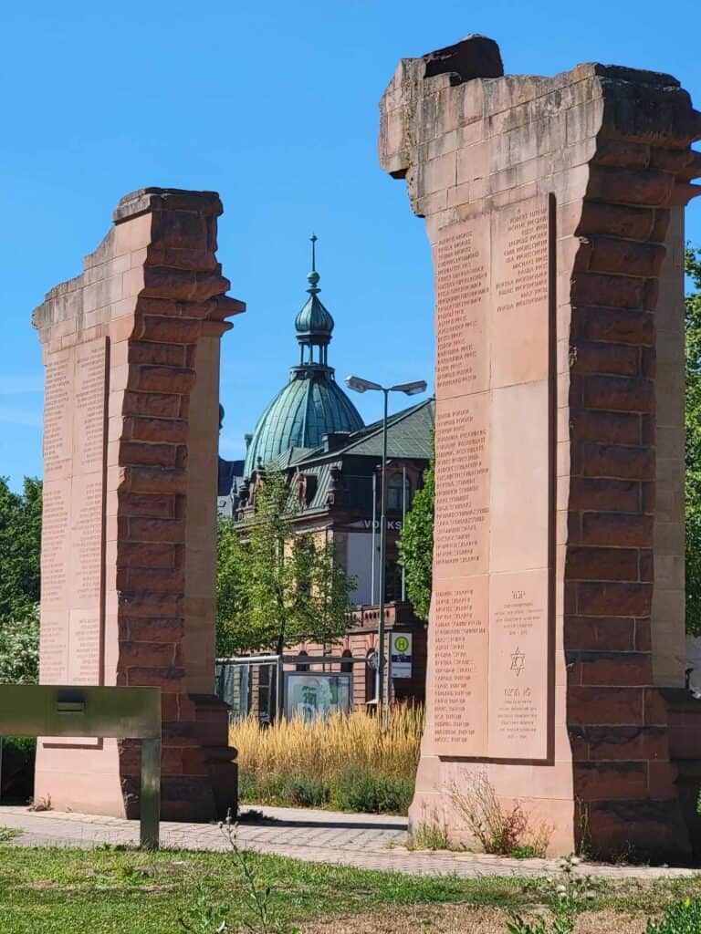 The memorial arch in red sandstone with names inscribed