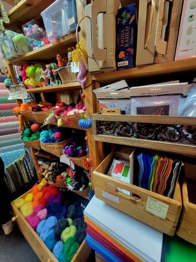 Wool yarn in many colors, felt, and papers in a craft store