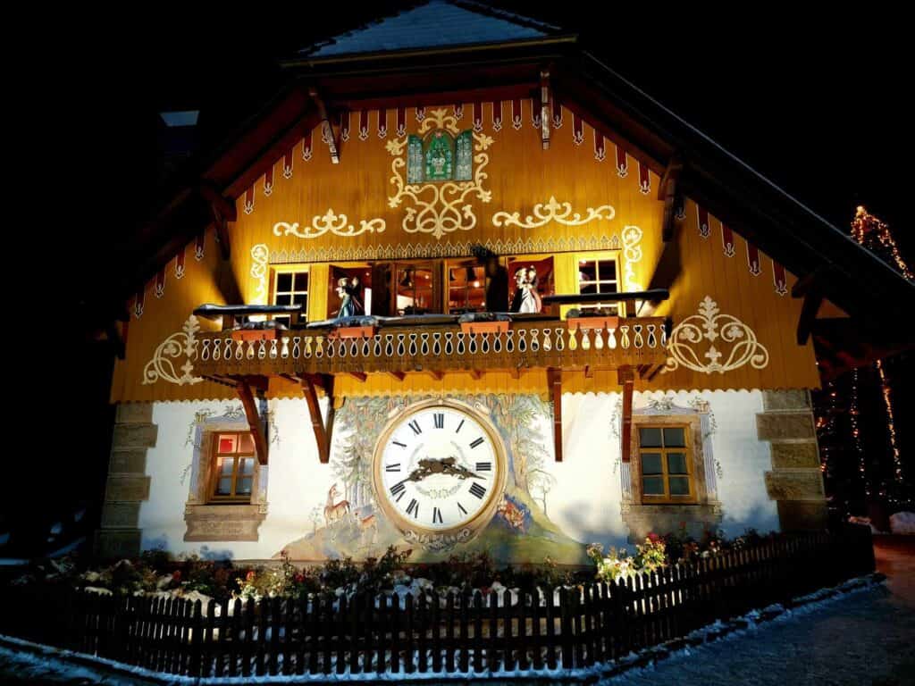 A large cuckoo clock on the side of a building