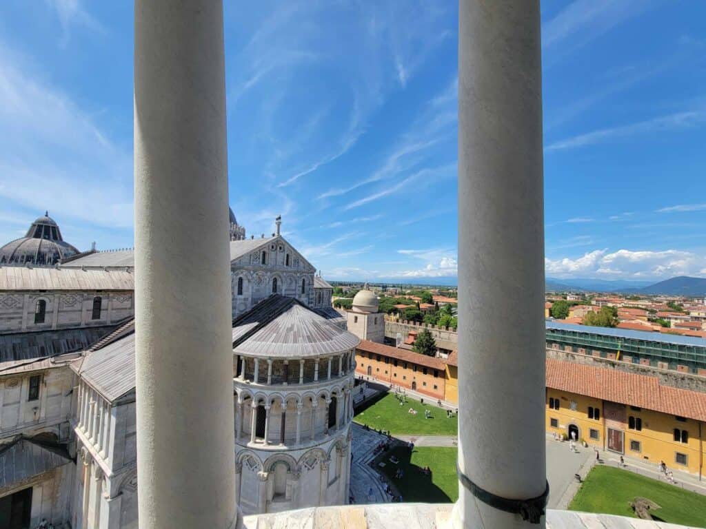 A white marble church from above and two white marble columns on the side