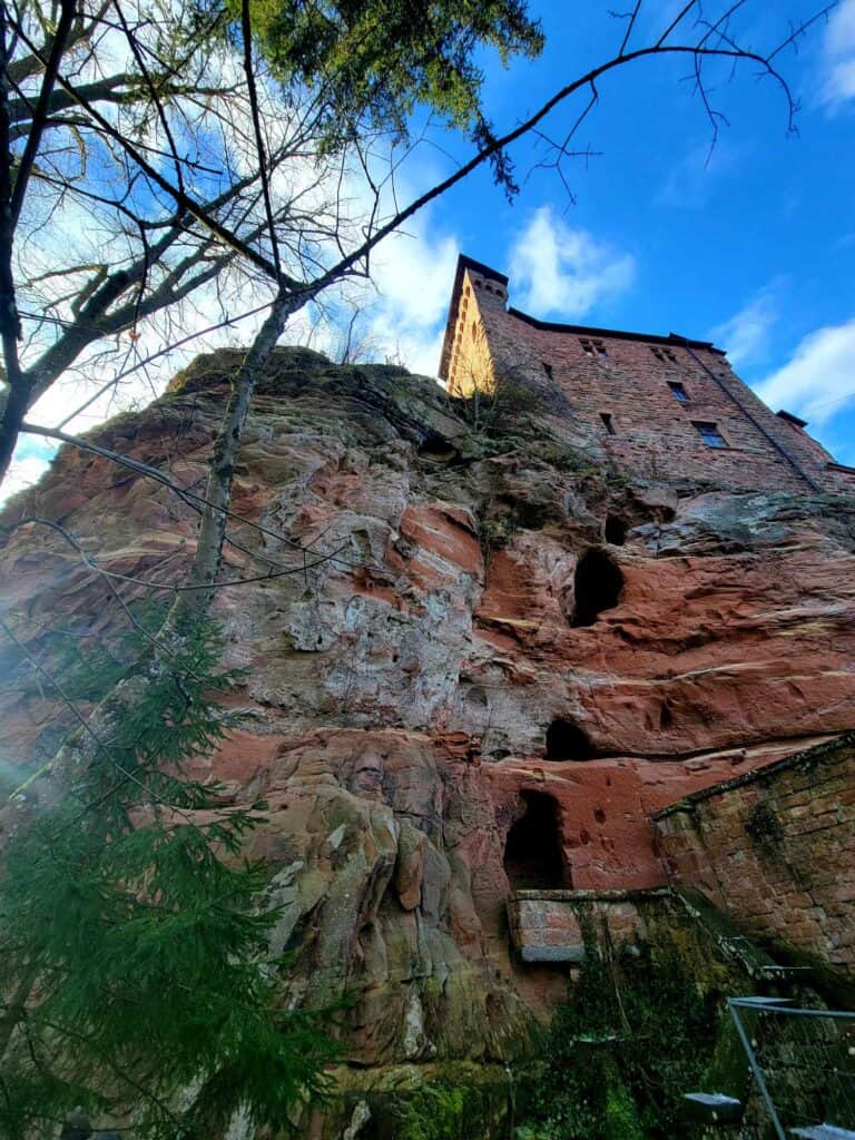 Square castle turret on top of layered sandstone outcrop