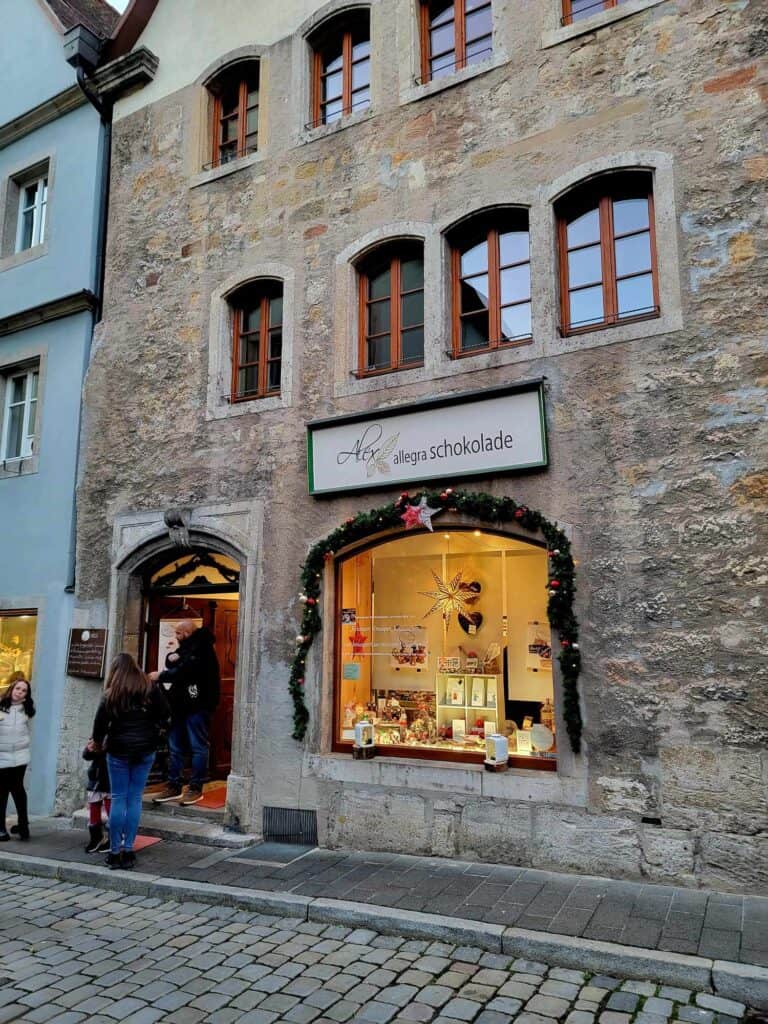 A stone building with a window filled with chocolate