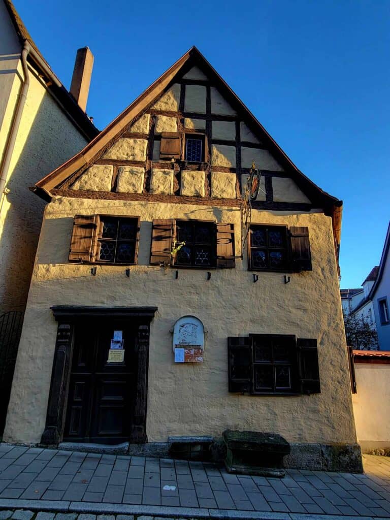 A medieval timbered house with shuttered windows