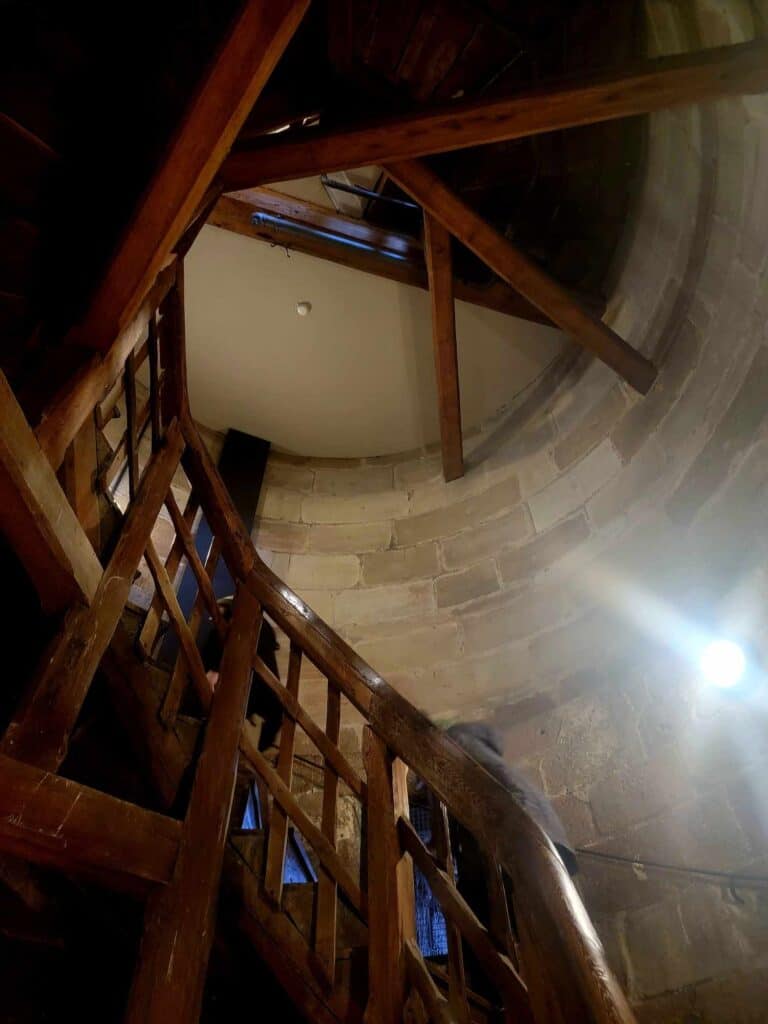 A wooden spiral staircase leads up the tower