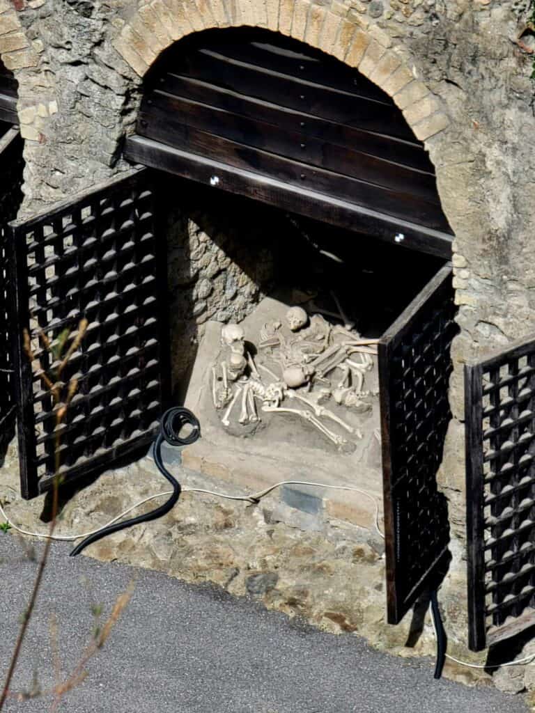 Pompeii vs. Herculaneum: Best Tips & Biggest Differences 21 Replicas of the skeletons found in the boathouse in Herculaneum