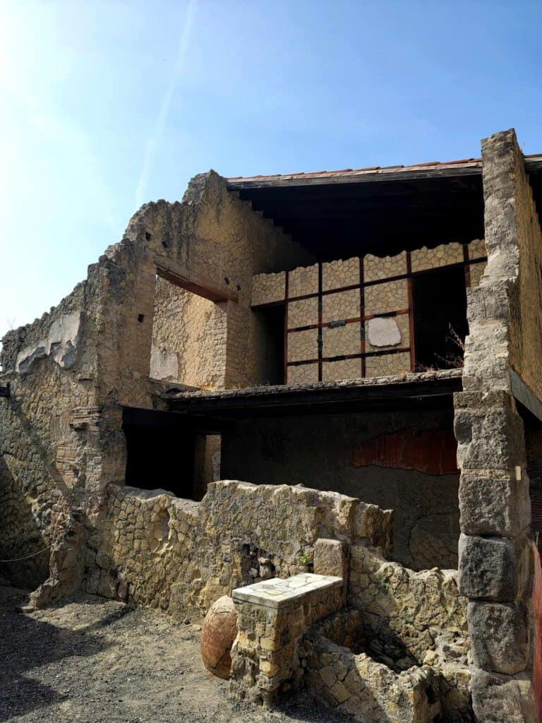 Pompeii vs. Herculaneum: Best Tips & Biggest Differences 5 A two story stone dwelling with back walls and floor intact