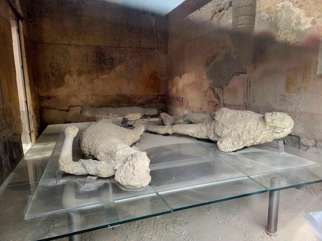 Pompeii vs. Herculaneum: Best Tips & Biggest Differences 20 The plaster casts of two women who died in a house in Pompeii, lying on the floor