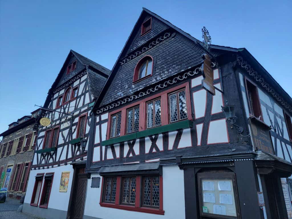 One Day in Bacharach: Best Guide to Germany's Hidden Gem on the Rhine 15 A half-timbered building in red, green, and white with leaded windows