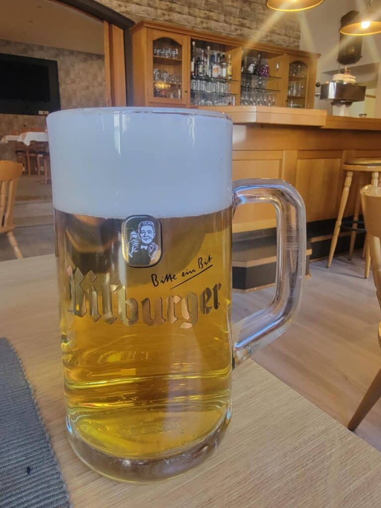 One Day in Bacharach: Best Guide to Germany's Hidden Gem on the Rhine 25 A huge mug of beer sits on a light wood table with a matching bar in the background
