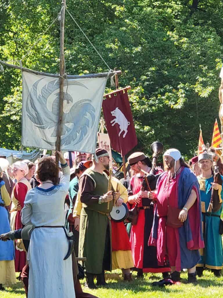 One Day in Bacharach: Best Guide to Germany's Hidden Gem on the Rhine 31 A large group of people holding banners with various animals and symbols, and wearing medieval clothing