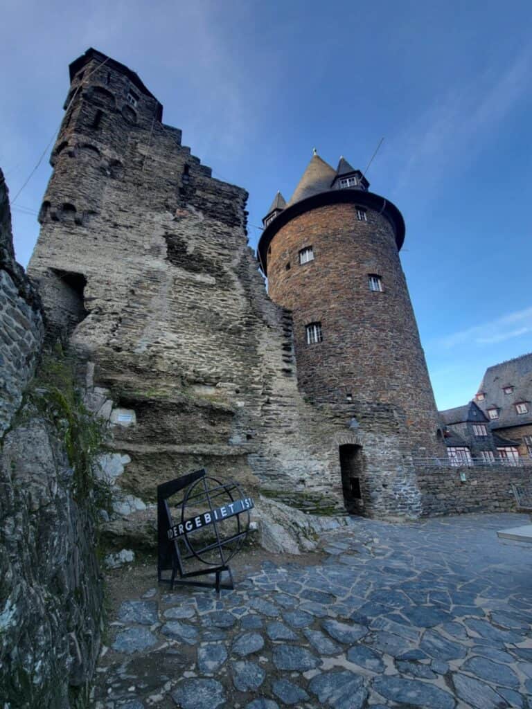 One Day in Bacharach: Best Guide to Germany's Hidden Gem on the Rhine 10 A stone castle tower and half ruined wing flanking a stone courtyard