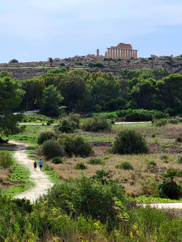 Two people walking the sacred road in Selinunte Archaeological Park in Sicily