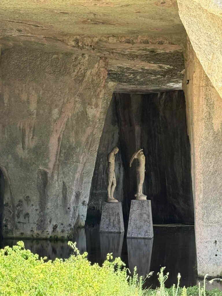 Statues in the cave of the ropemakers at the archaeological park of Siracusa