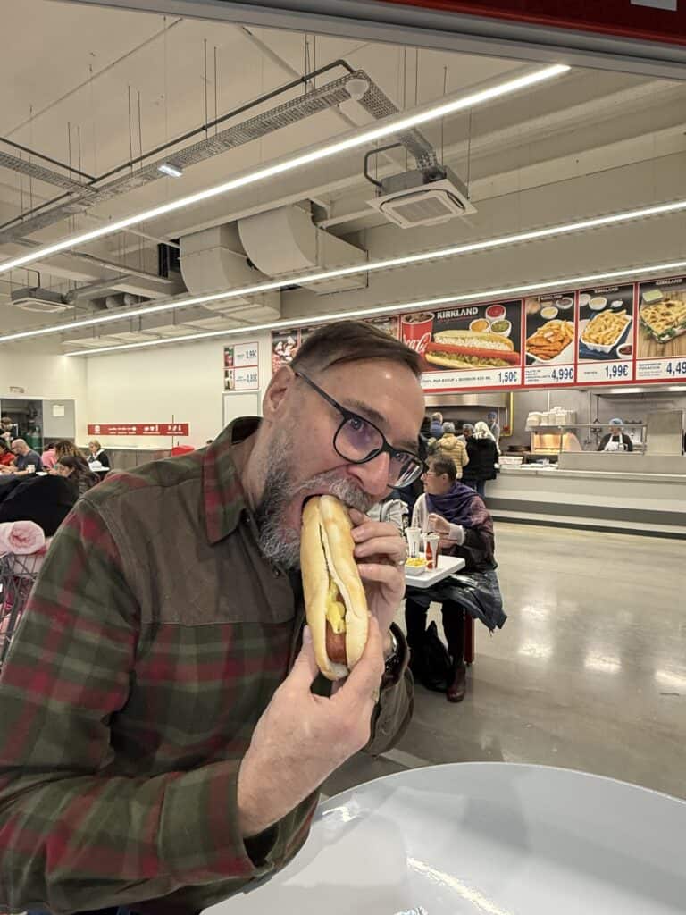 Man eating a giant hot dog at Costco in Mulhouse