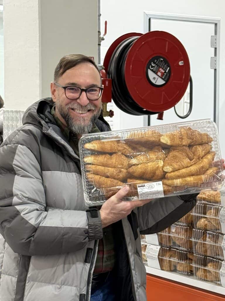 A very happy man with a box of croissants in Costco in Mulhouse France
