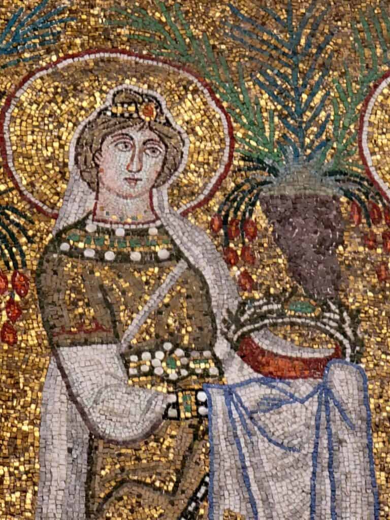 A golden mosaic of a woman inside Basilica di Sant’Apollinare Nuovo in Ravenna Italy