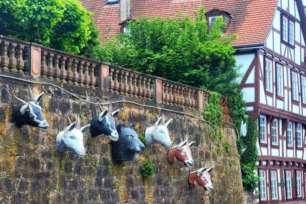 A wall decorated with goats and a bear from a German fairytale in Marburg Germany