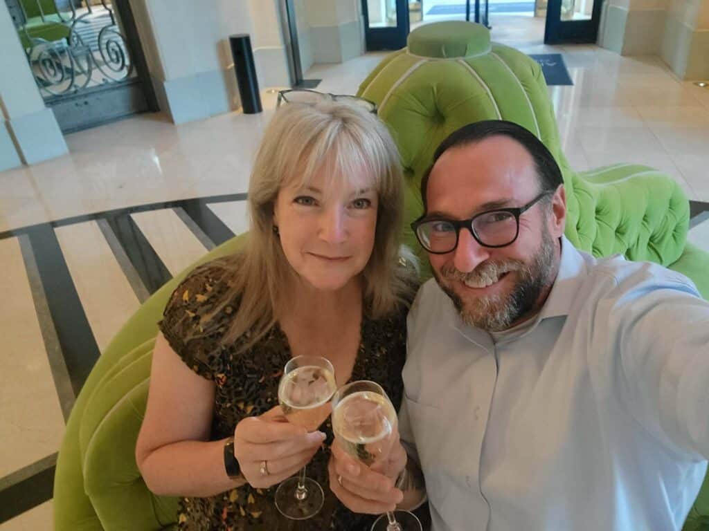A couple drinks champagne at the Waldorf Astoria Trianon Palace Versailles