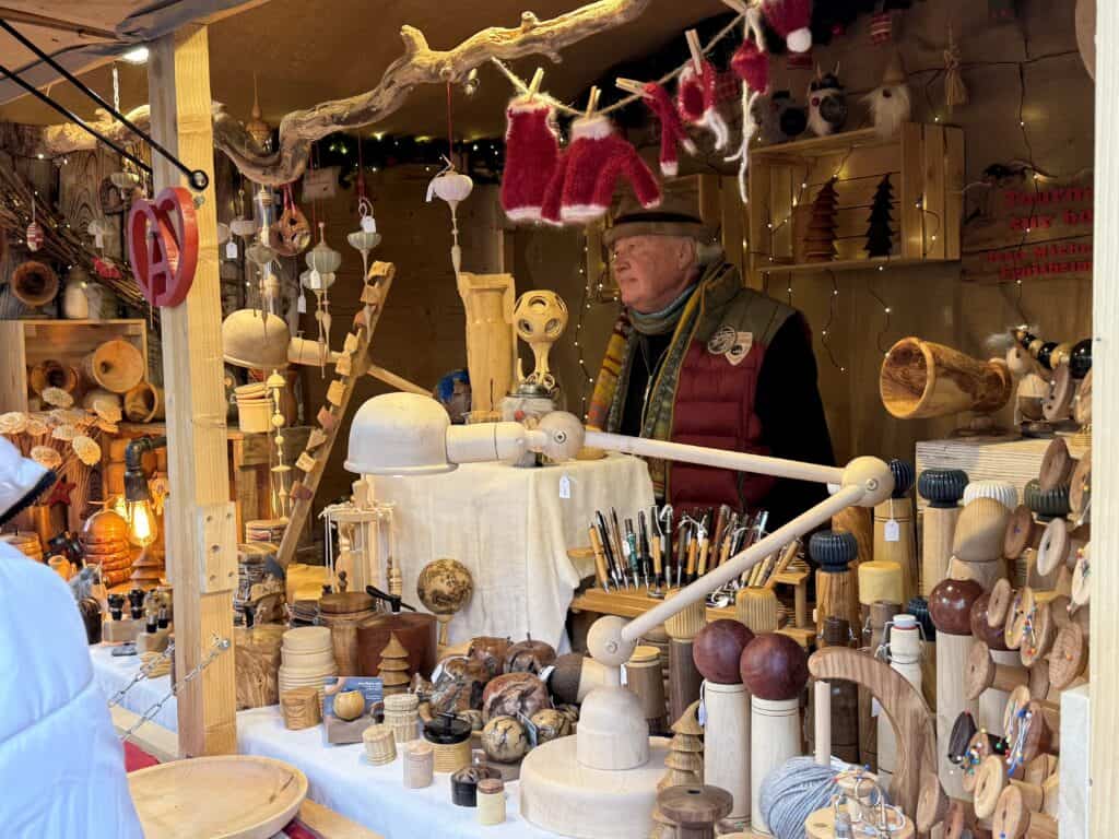 Eguisheim Christmas Market 2026: The Most Beautiful Village in Alsace Delivers 11 A Christmas stall with wooden crafts in Eguisheim