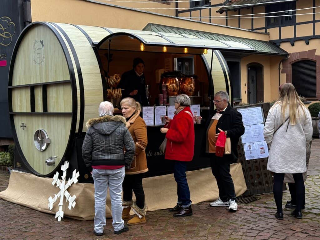 Eguisheim Christmas Market 2026: The Most Beautiful Village in Alsace Delivers 7 Wine barrel shaped Christmas market stall in Eguisheim
