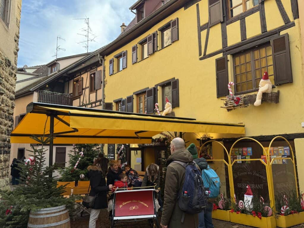 Eguisheim Christmas Market 2026: The Most Beautiful Village in Alsace Delivers 15 A bright yellow house in Eguisheim