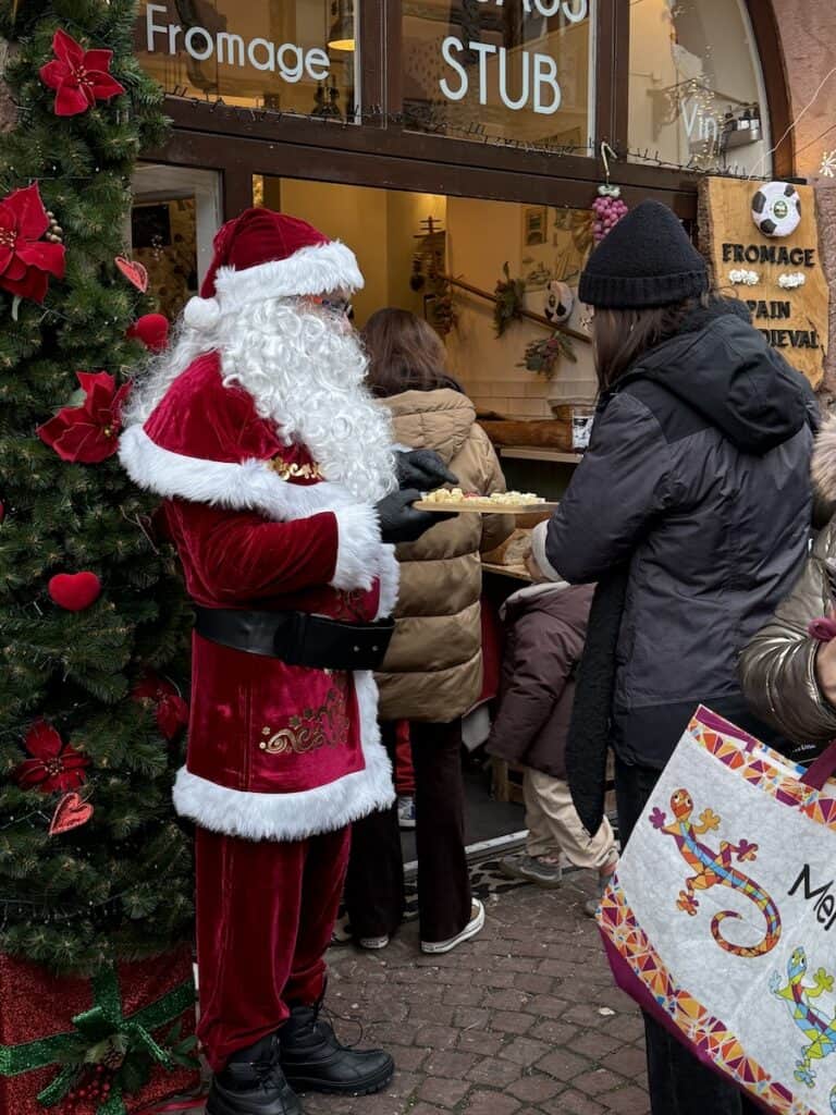Kaysersberg Christmas Market 2026: Alsace's Most Underrated Hidden Gem 6 Santa hands out cheese at the Kaysersberg Christmas market