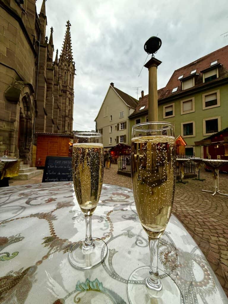Mulhouse Christmas Market 2026: The Most Elegant Surprise in Alsace 13 Champagne glasses with a monument to Johann Heinrich Lambert at the Mulhouse Christmas market