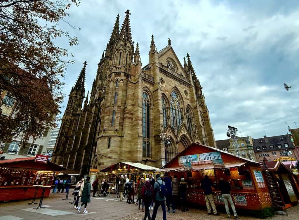Mulhouse Christmas Market 2026: The Most Elegant Surprise in Alsace 3 Mulhouse Temple of Saint Etienne with Christmas market stalls