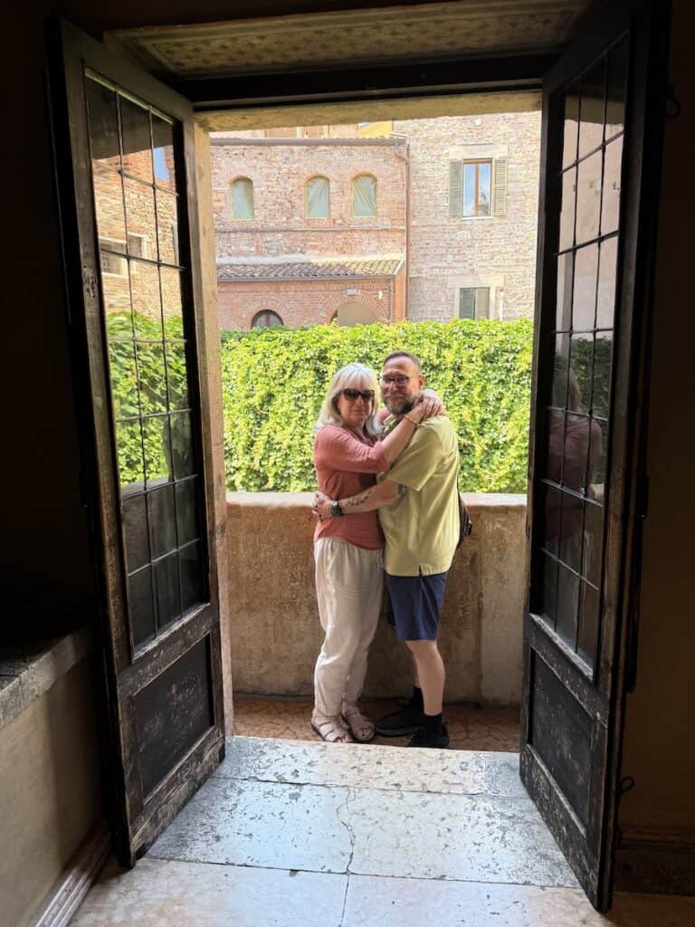 Juliet's Balcony in Verona: New Entrance, New Fee, Still Worth It in 2026? 11 A couple on Juliet's balcony in Verona