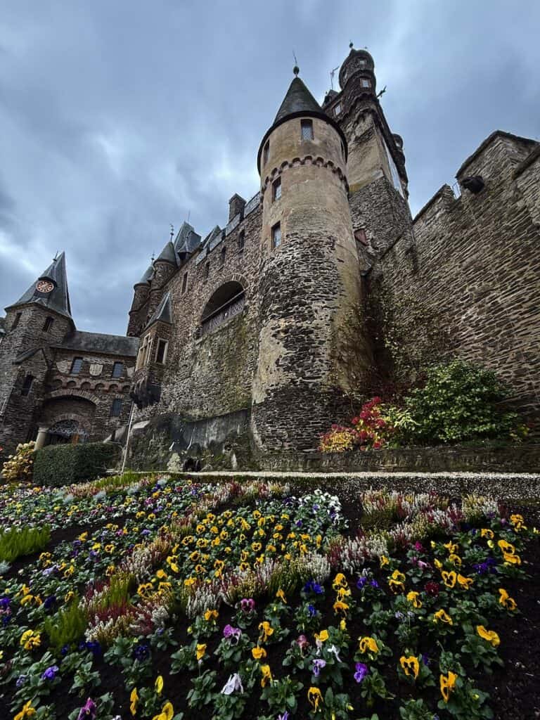 Cochem Castle: A Complete Guide to Visiting Reichsburg Cochem 4 Exterior of Cochem Castle with pansy garden